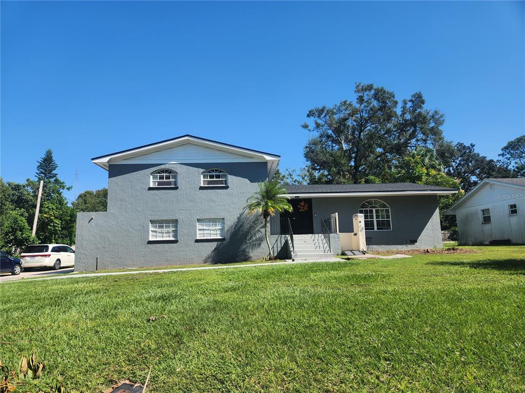 a front view of house with yard and outdoor seating