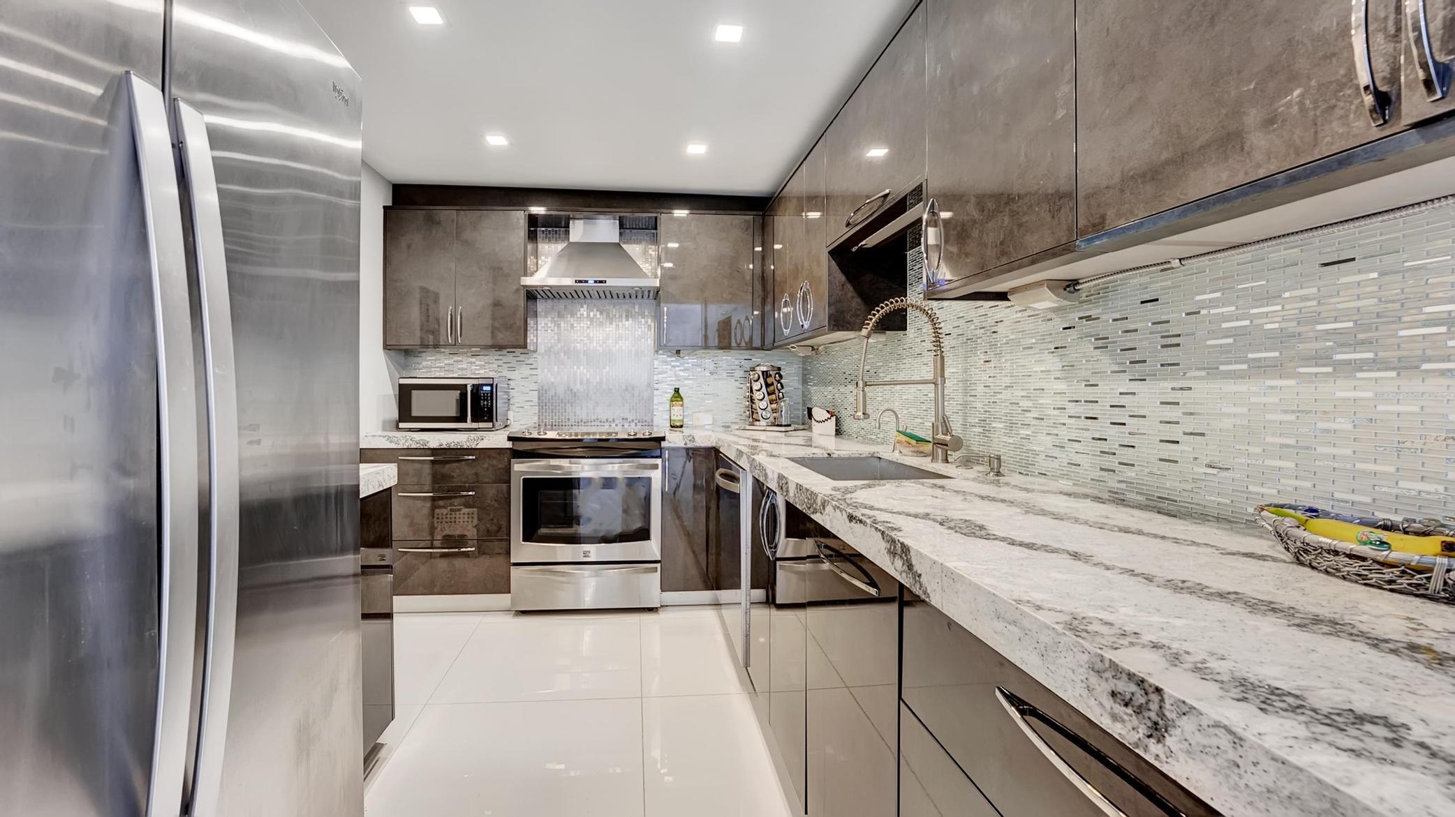 a kitchen with a sink stainless steel appliances and cabinets