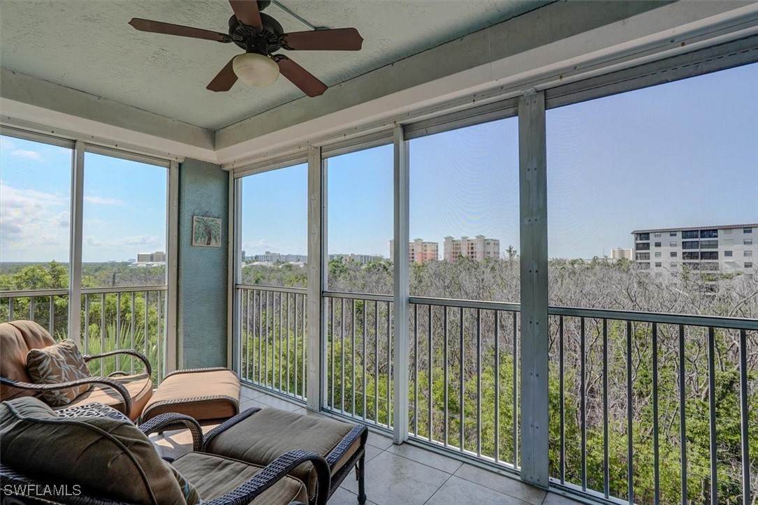 a living room with furniture and a floor to ceiling window