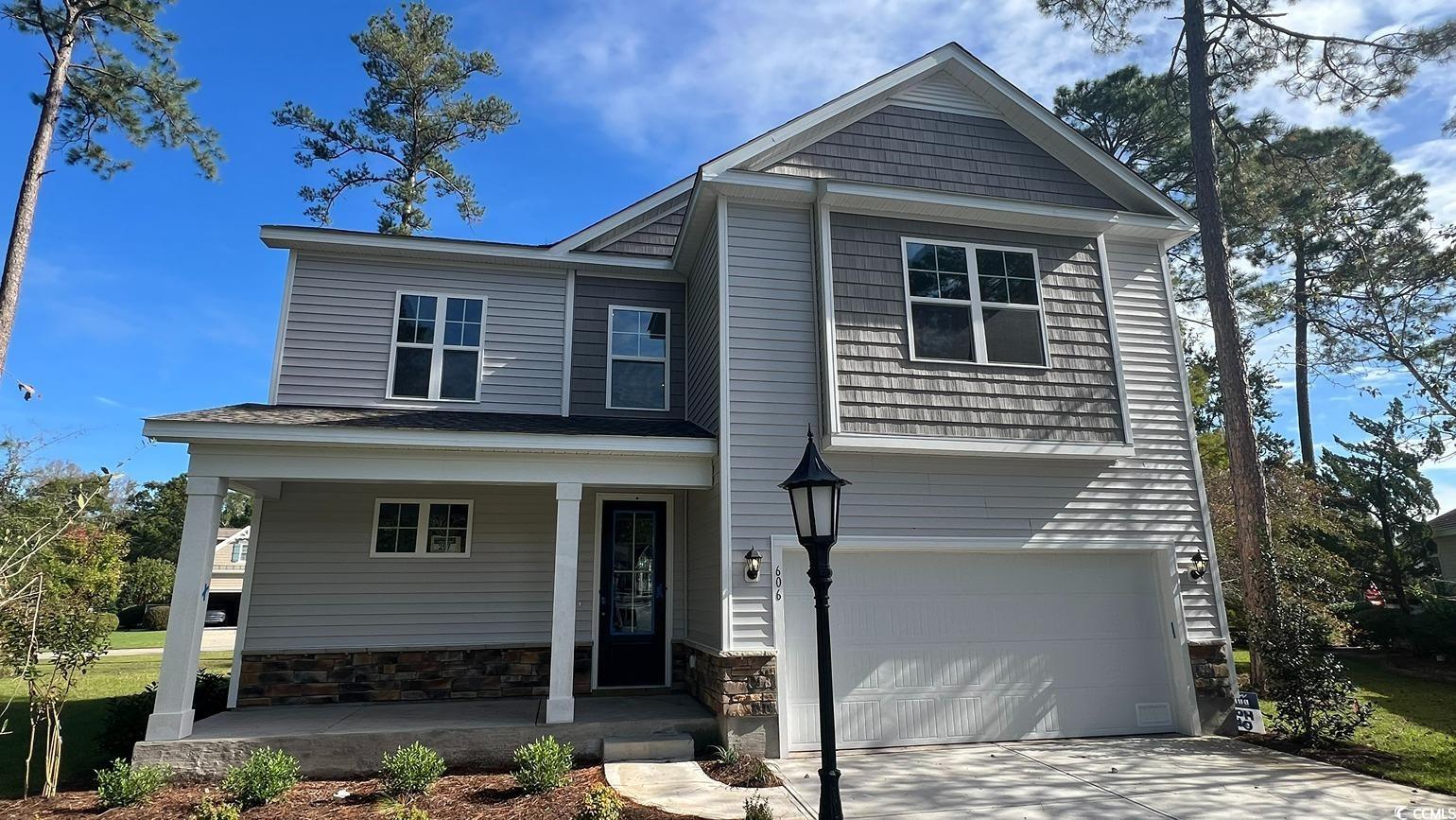 Front facade featuring a garage and covered porch