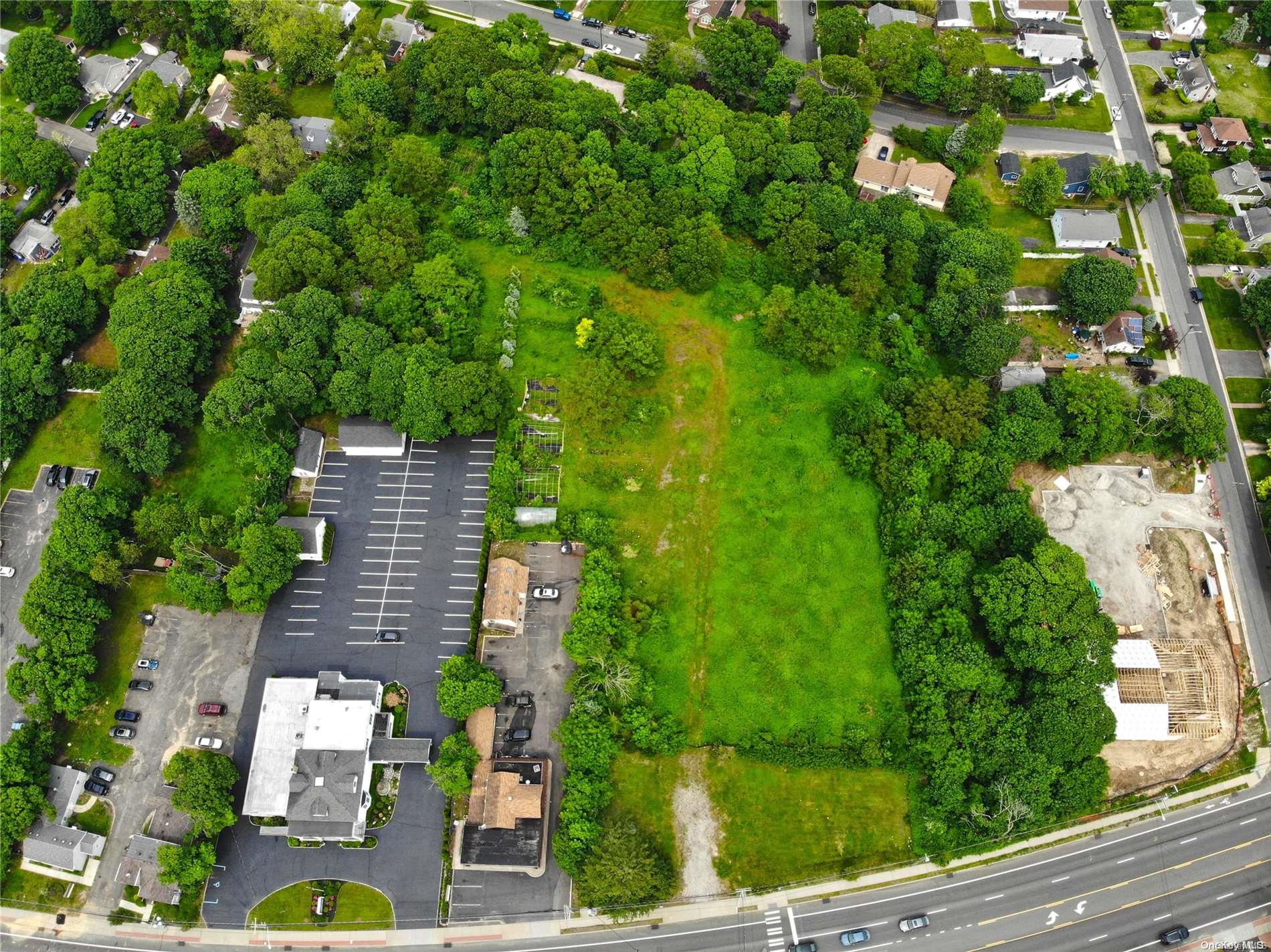 an aerial view of residential house with outdoor space and trees all around