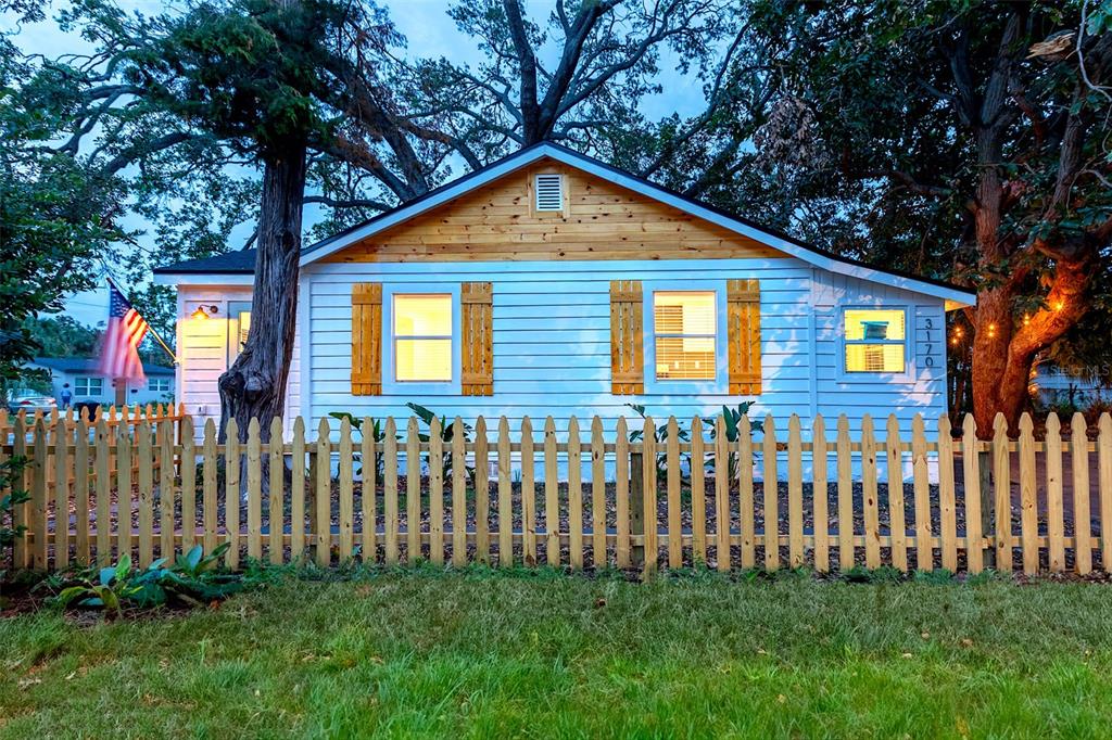 a view of a house with wooden fence