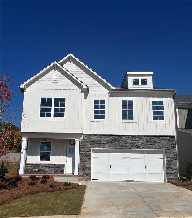 a front view of a house with garage