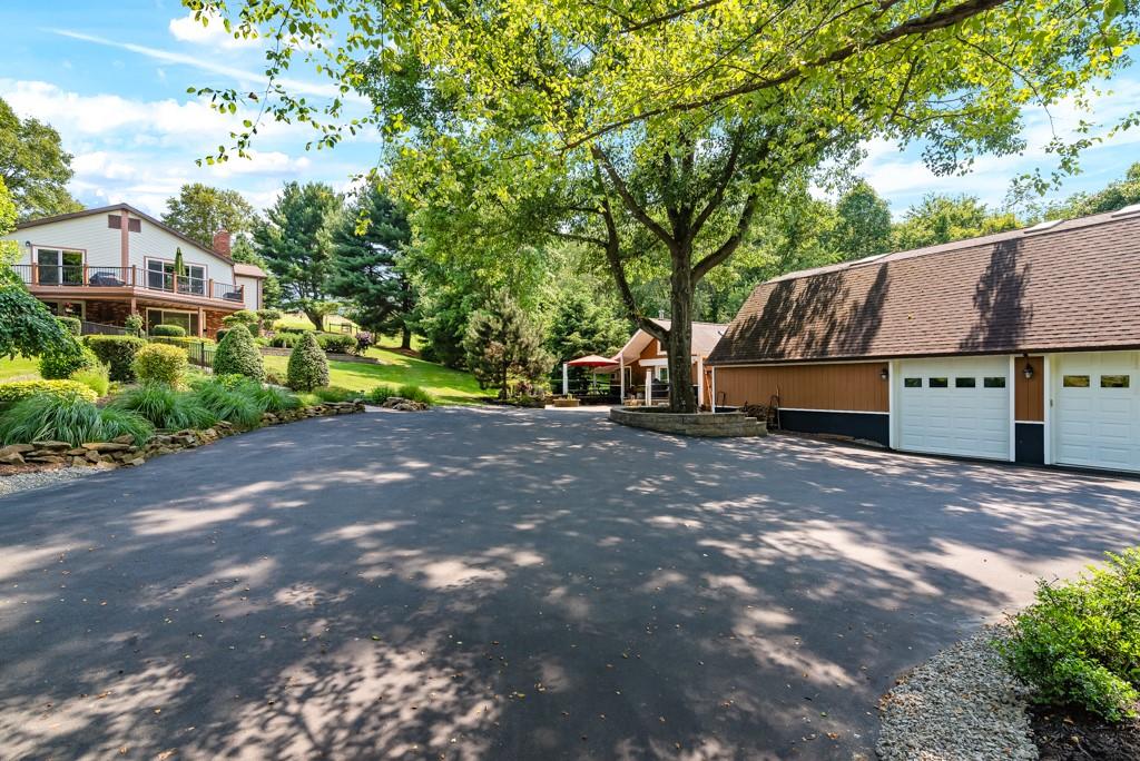 a view of a house with a yard and tree s