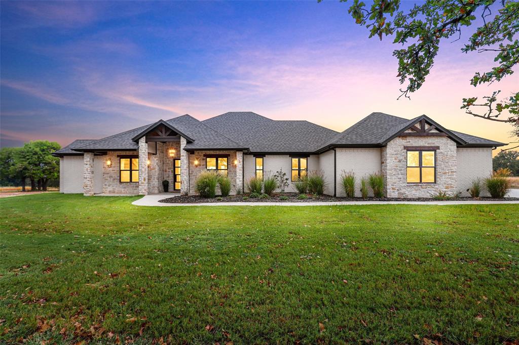 a front view of a house with a yard