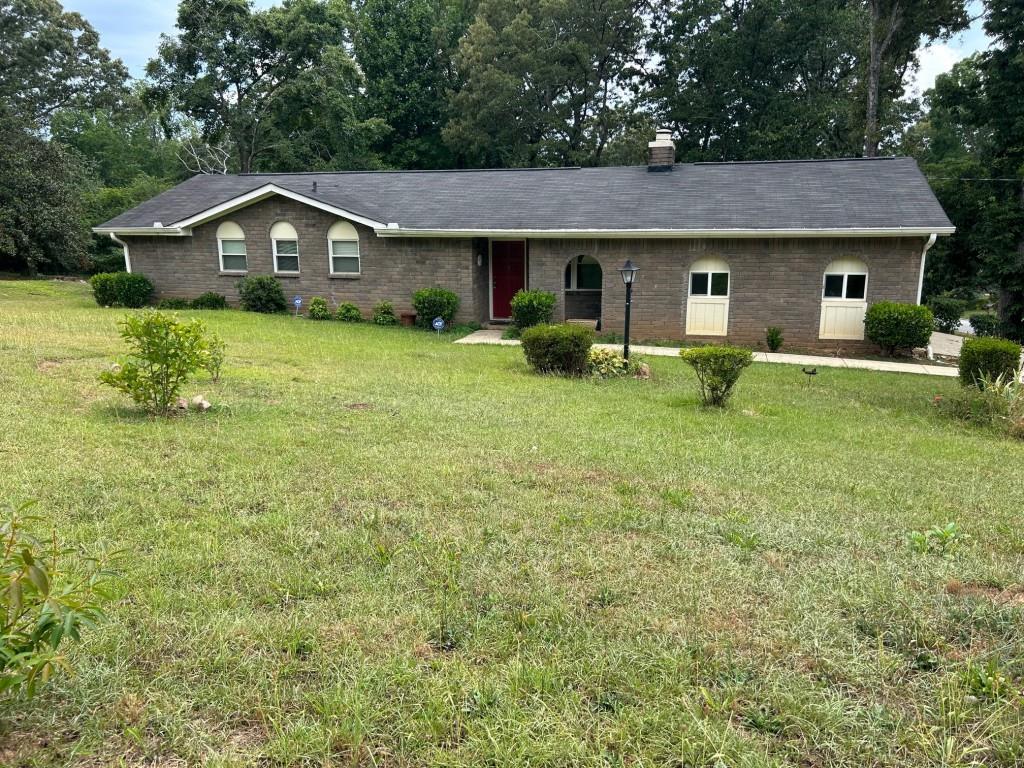 a front view of house with yard and green space