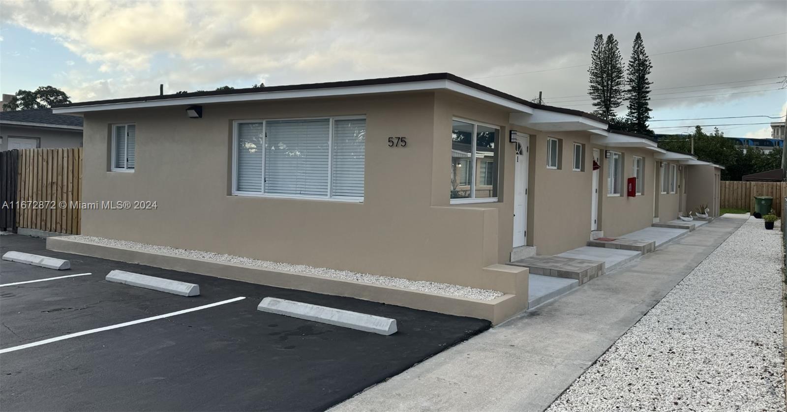 a front view of a house with parking space