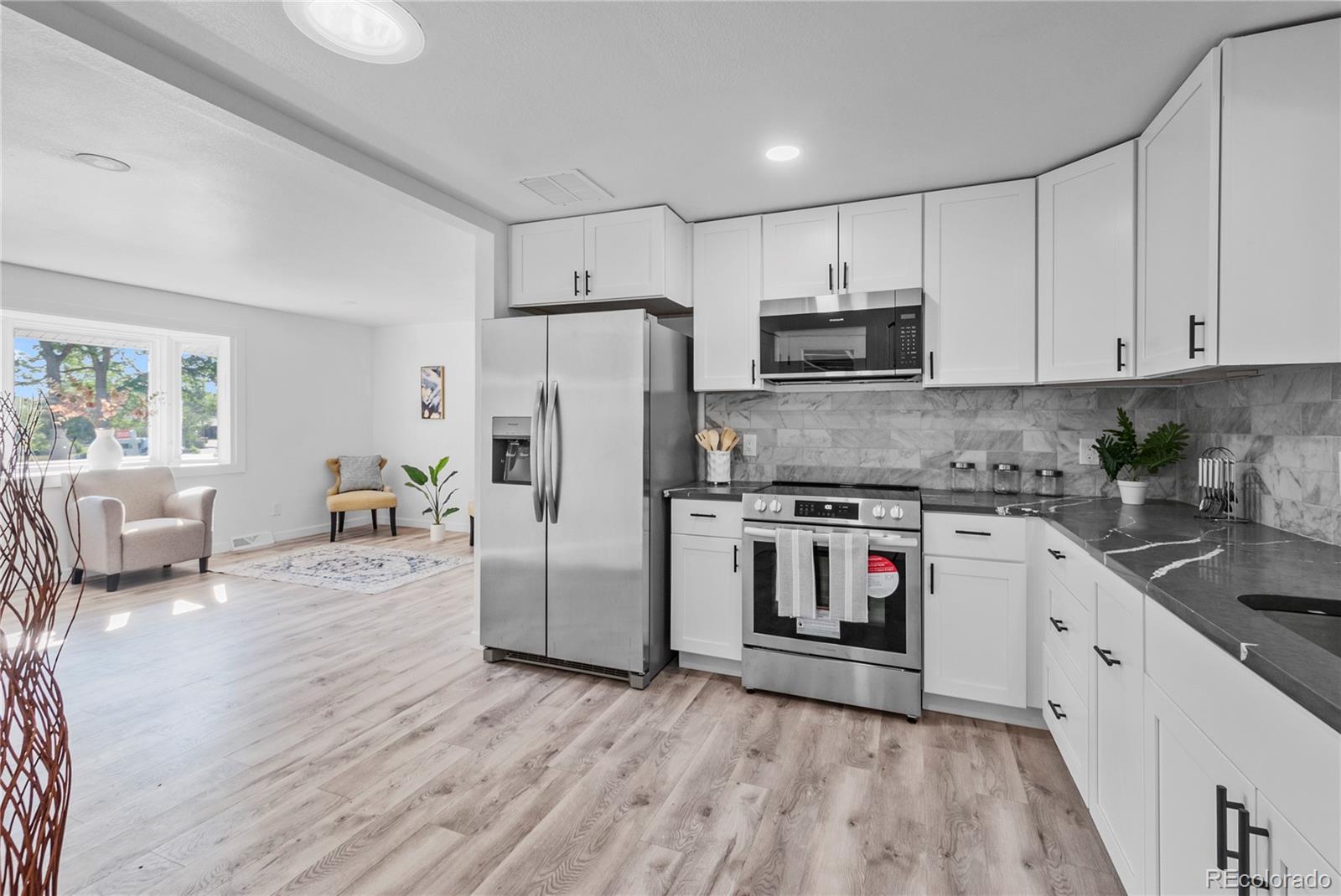 a kitchen with stainless steel appliances a stove a sink and a refrigerator