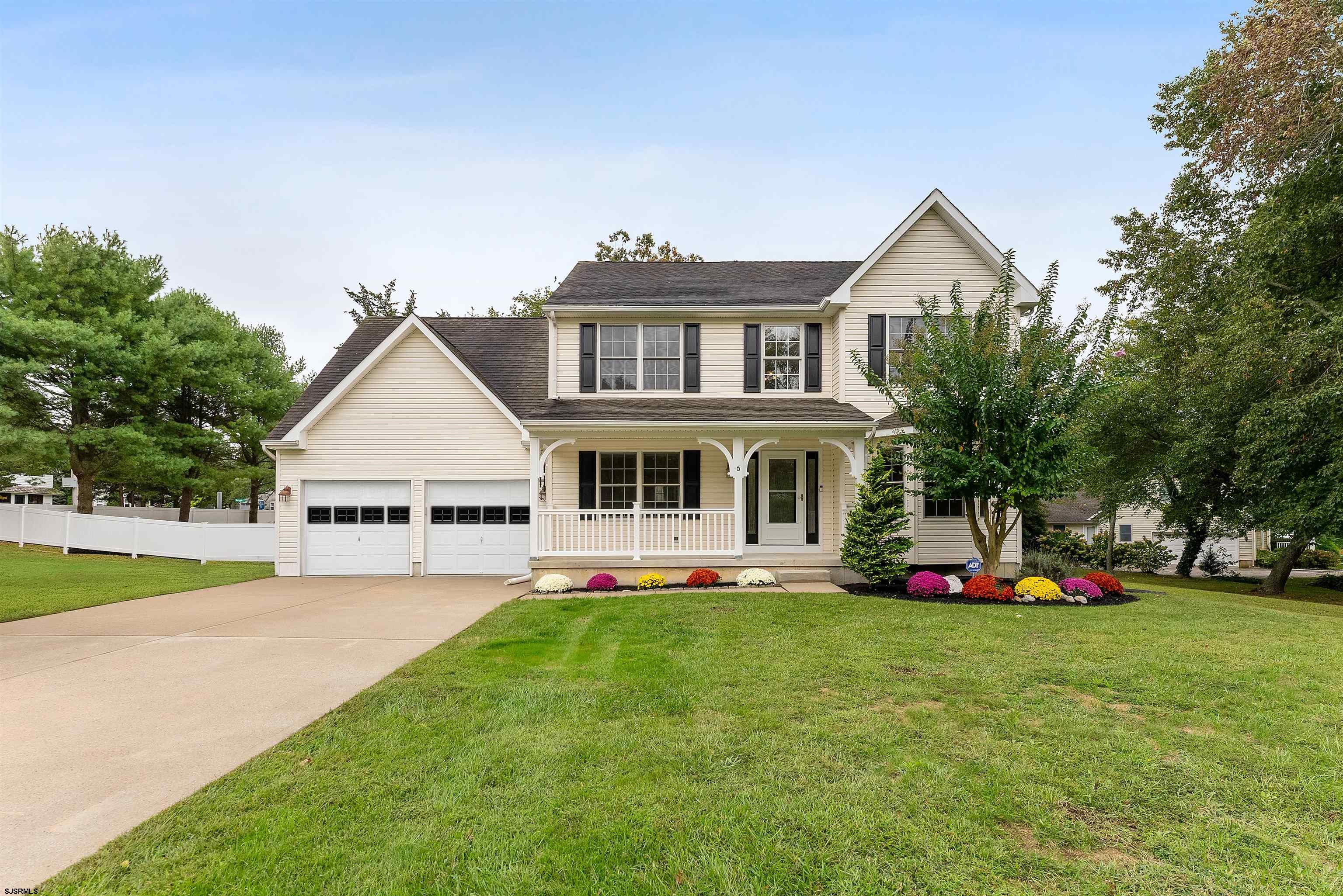 a view of a house with a big yard and potted plants