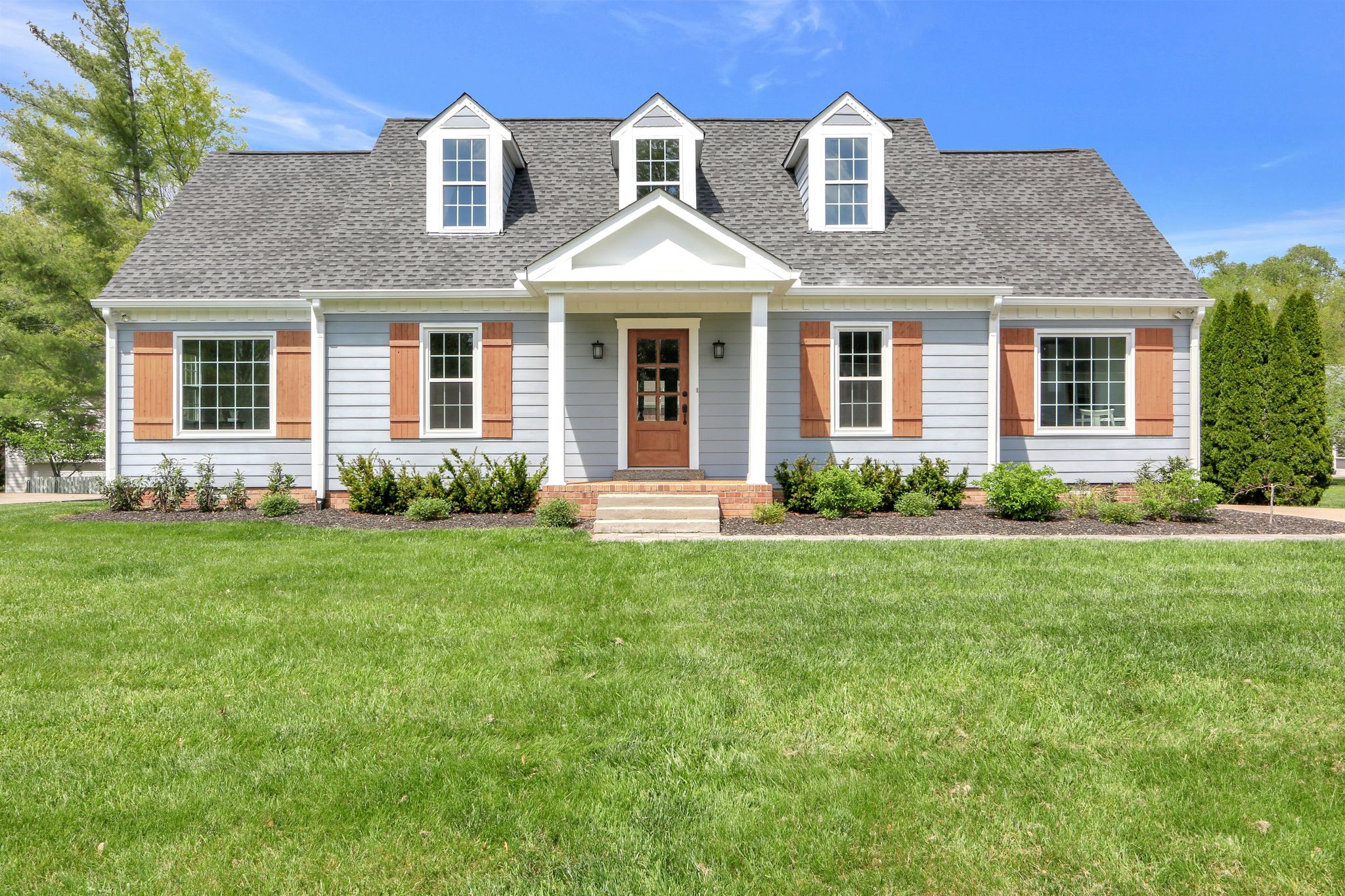 a front view of a house with a yard