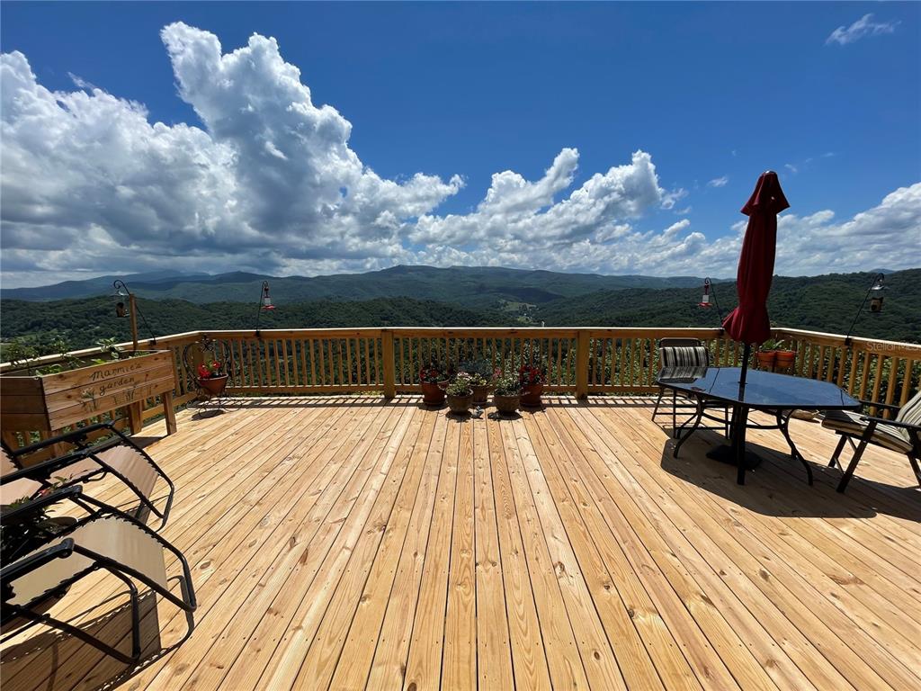 a view of a terrace with wooden floor and iron fence