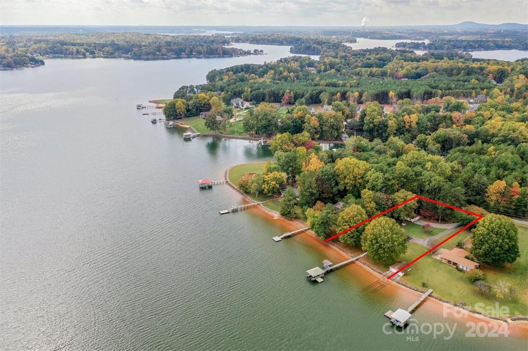 an aerial view of a house with a lake view