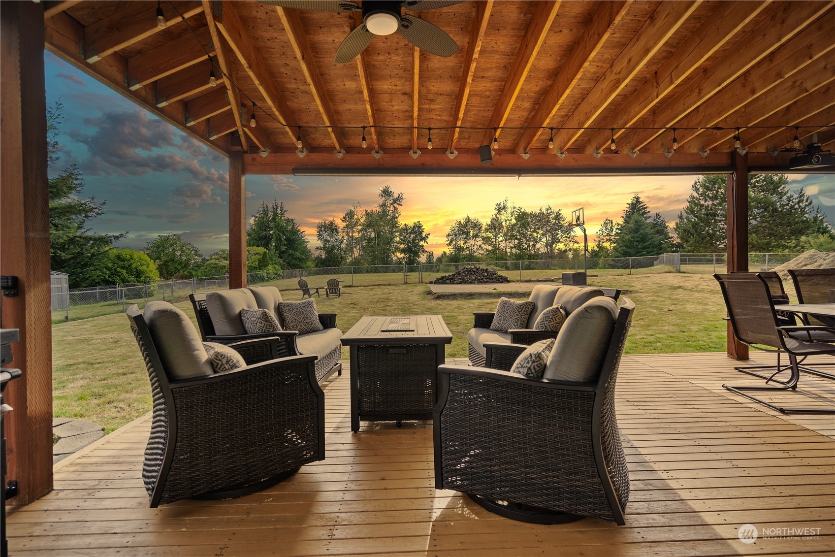 a roof deck with couches and wooden floor