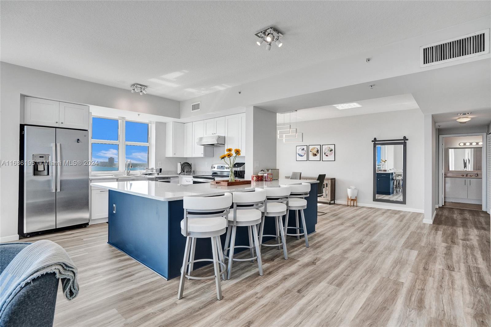 a large kitchen with a table and chairs