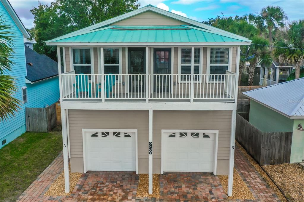 a view of a house with a yard and deck