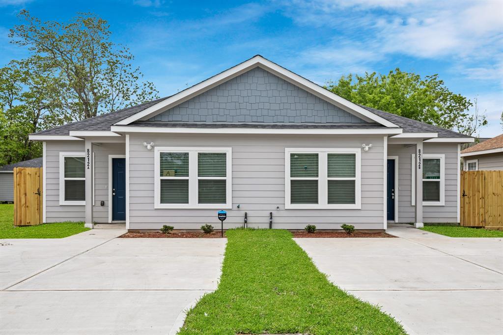 a front view of a house with a yard and outdoor seating