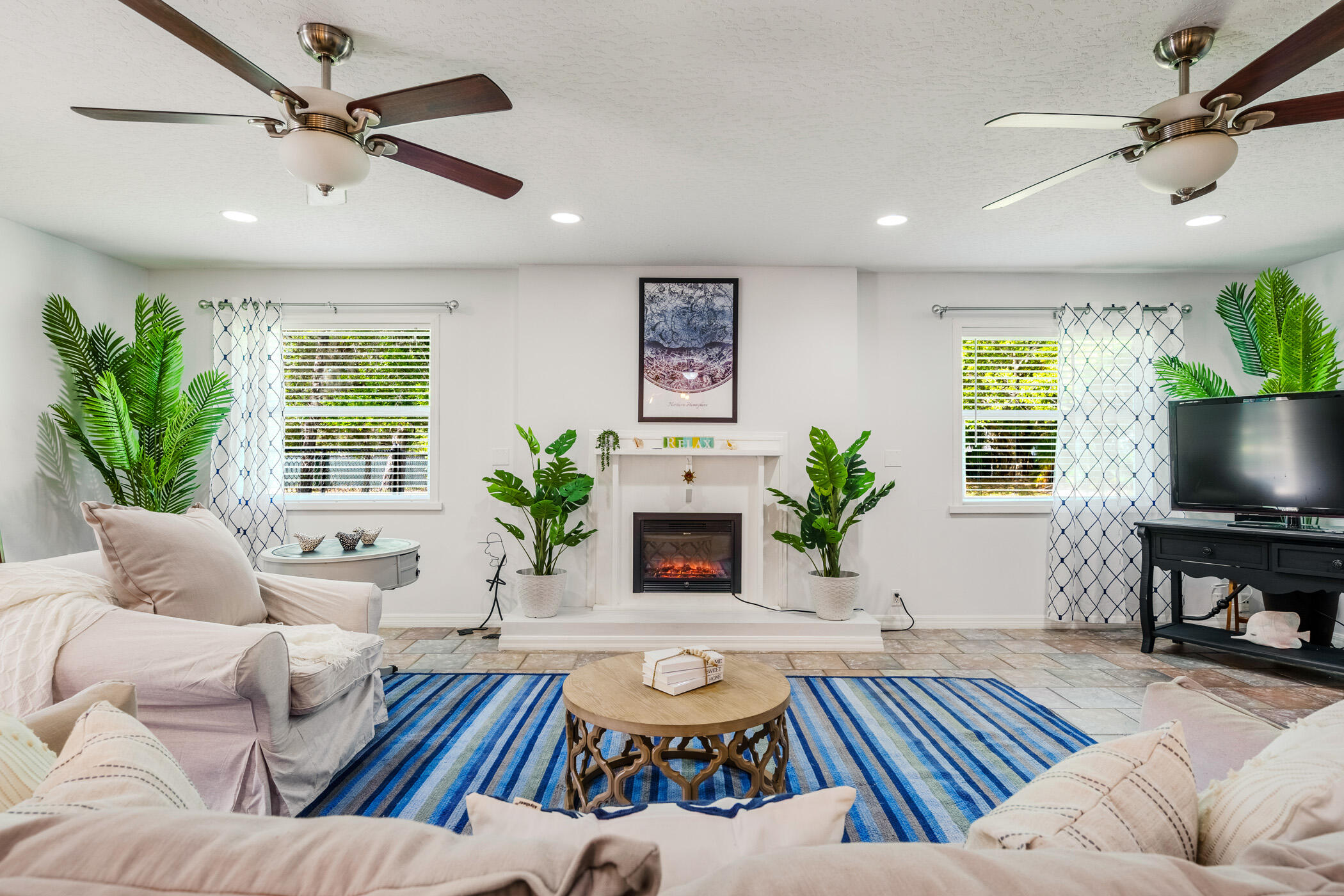 a living room with furniture a window and a fireplace