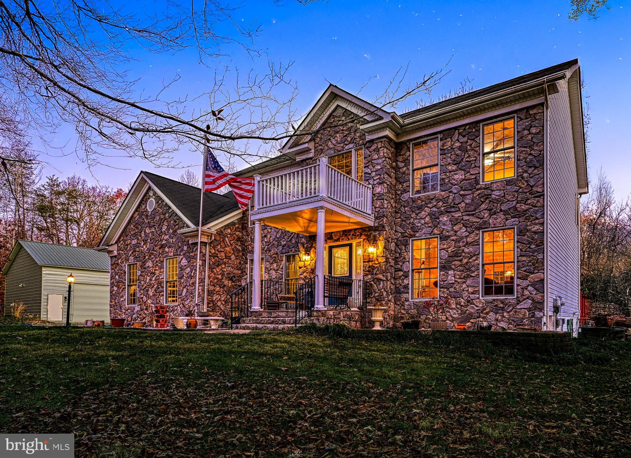 a view of a house with a large window and a yard