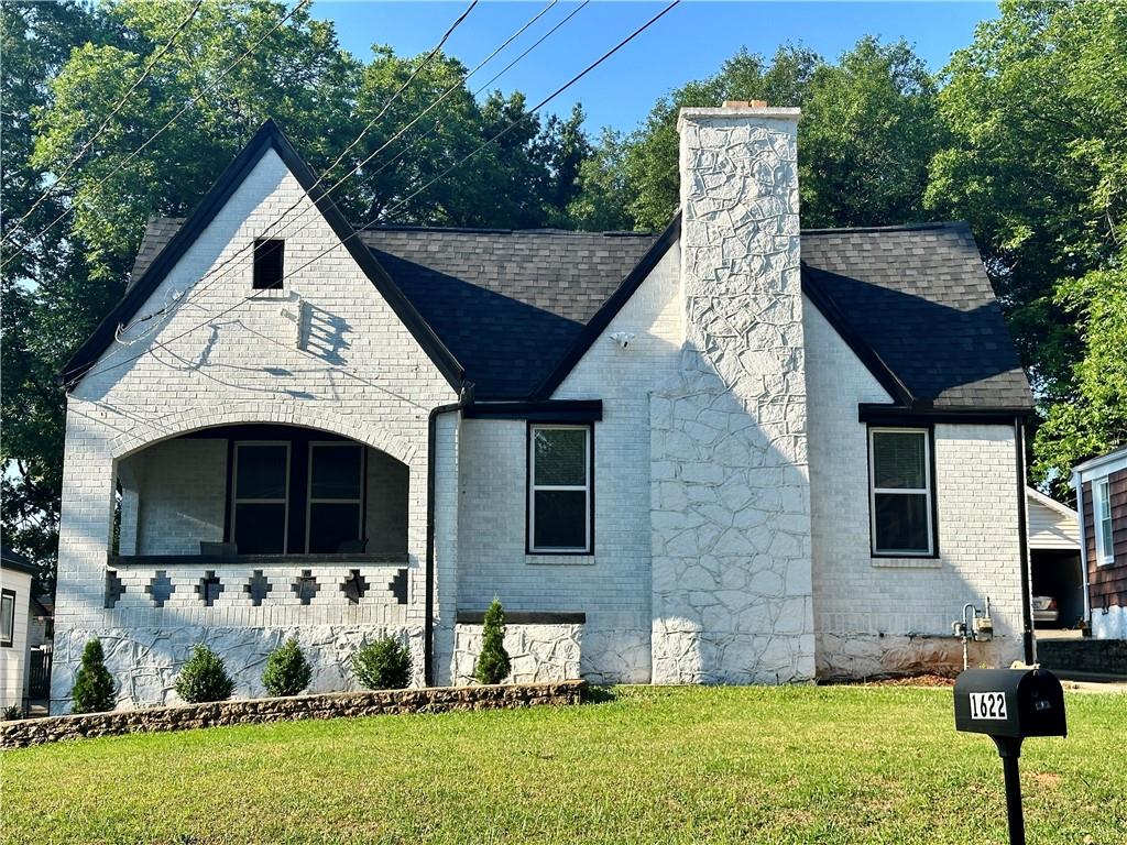 a front view of a house with garden