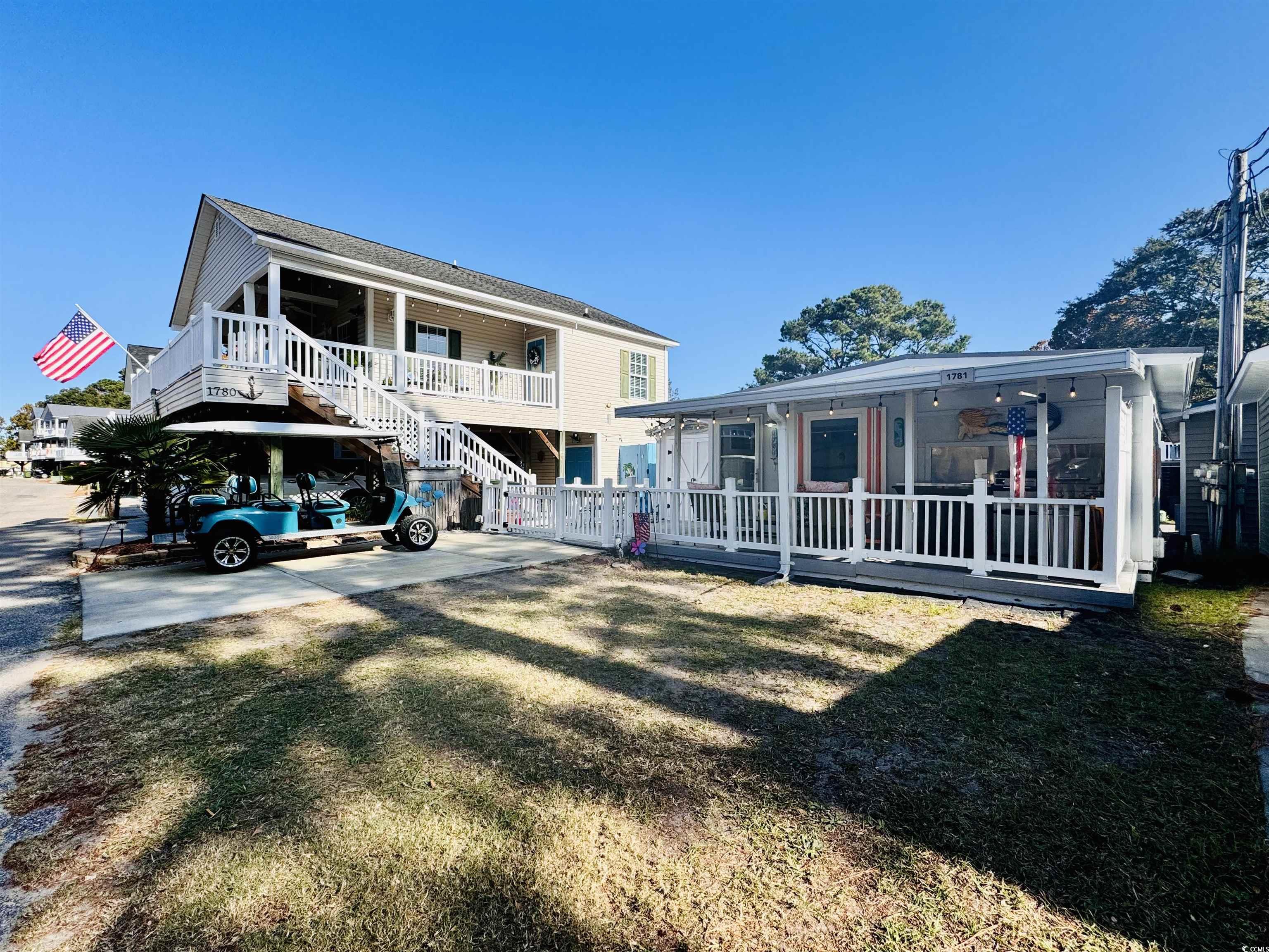 Back of house featuring covered porch, a carport,