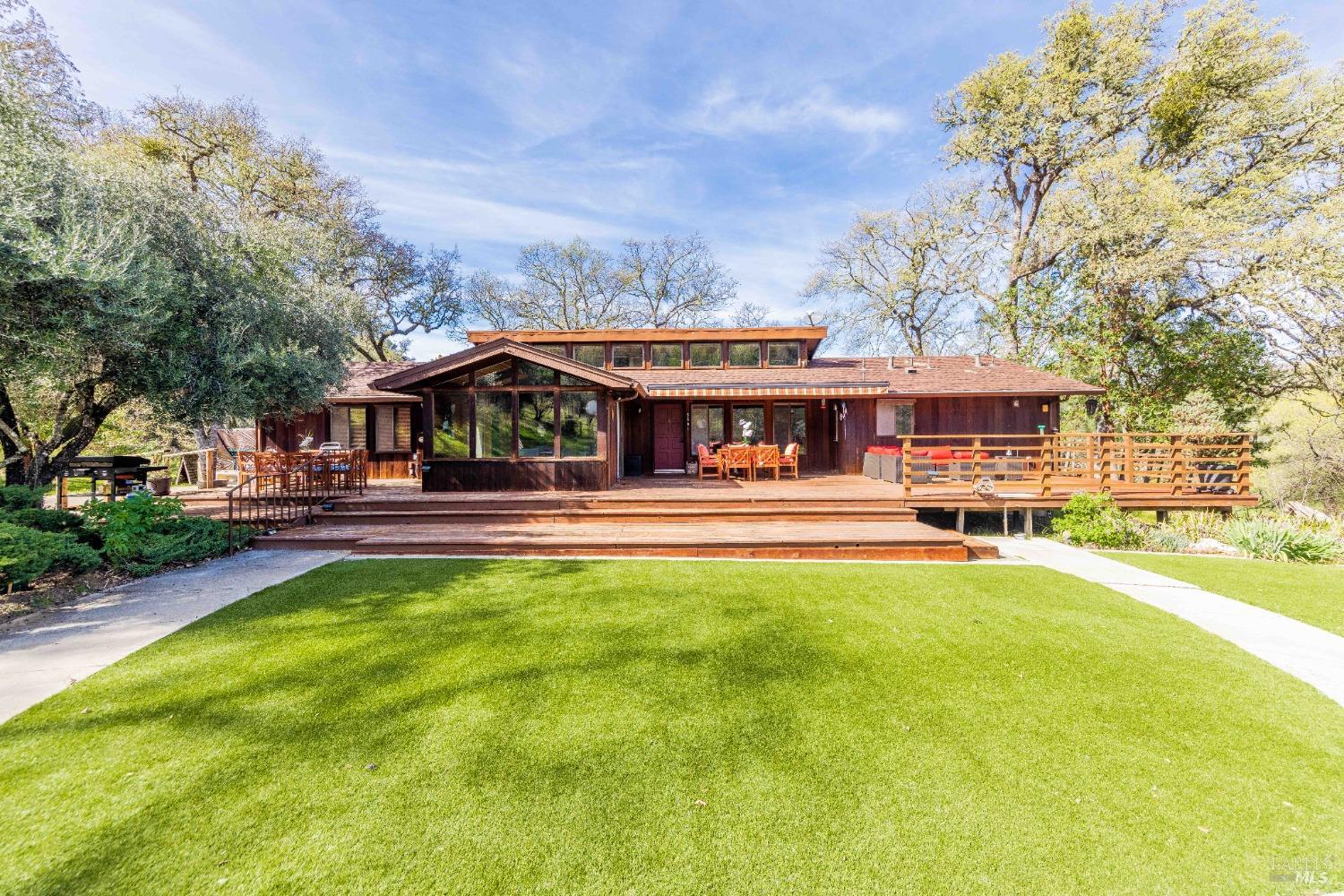 a swimming pool view with a seating space and garden view