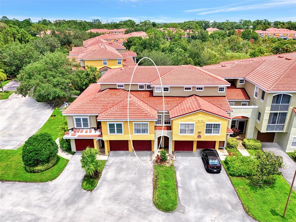 an aerial view of a house with yard swimming pool and outdoor seating