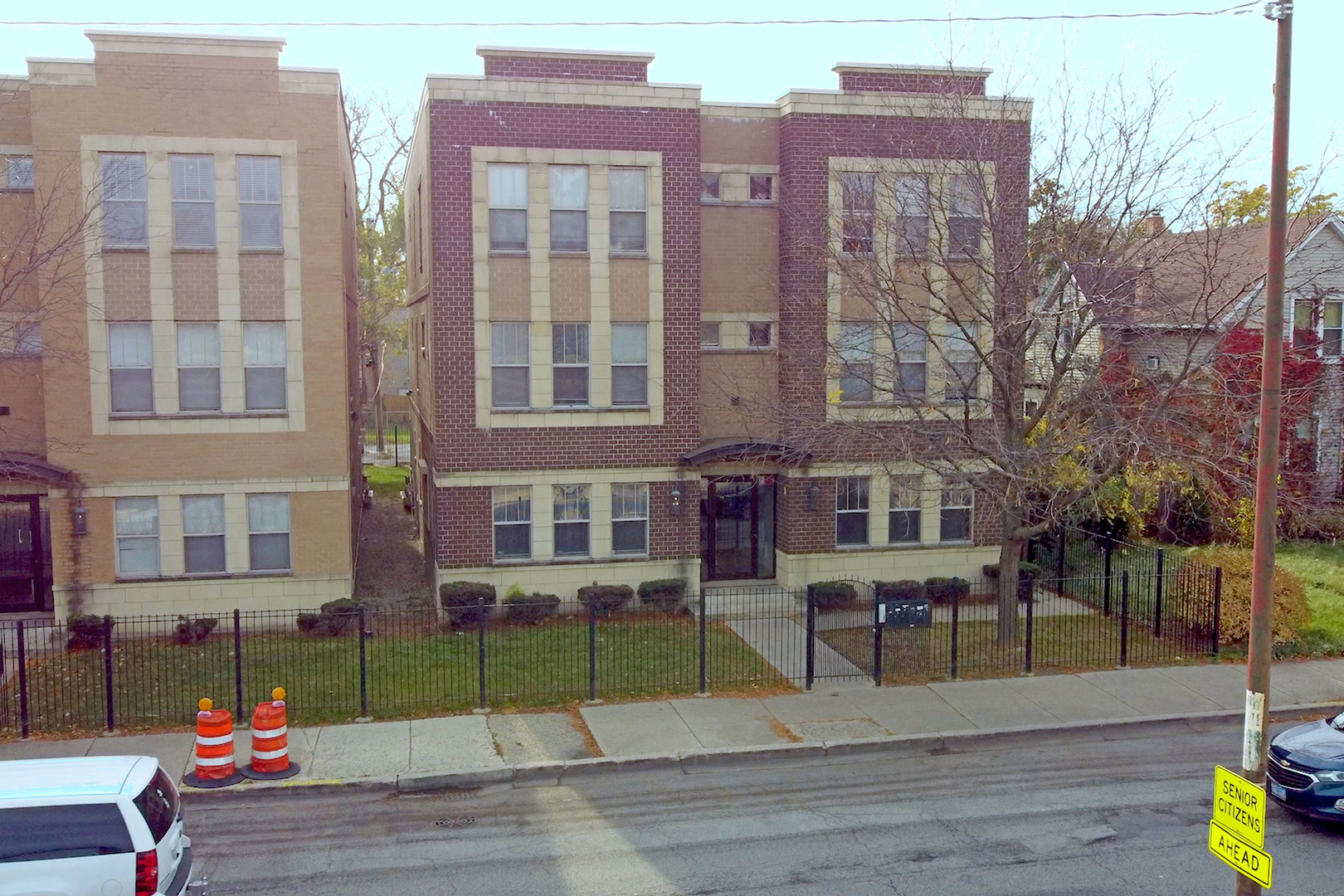 a view of a brick building next to a yard