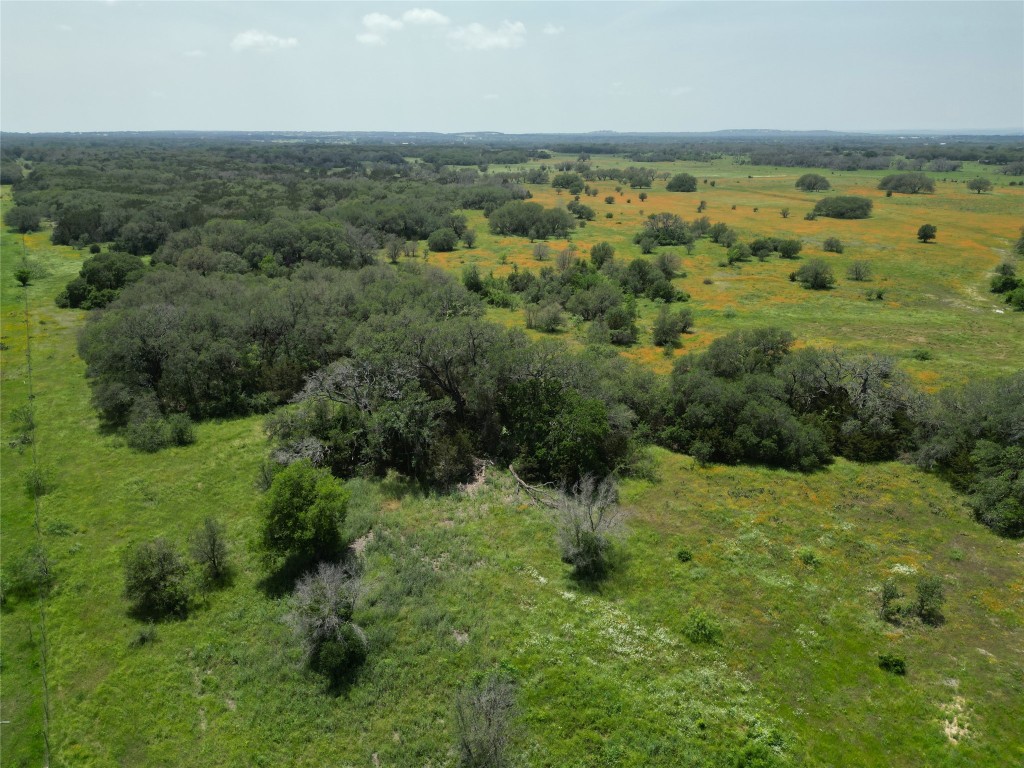 an aerial view of a houses with a yard