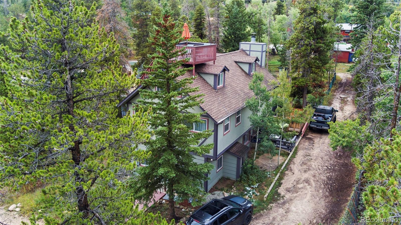 an aerial view of a house with a yard and garden