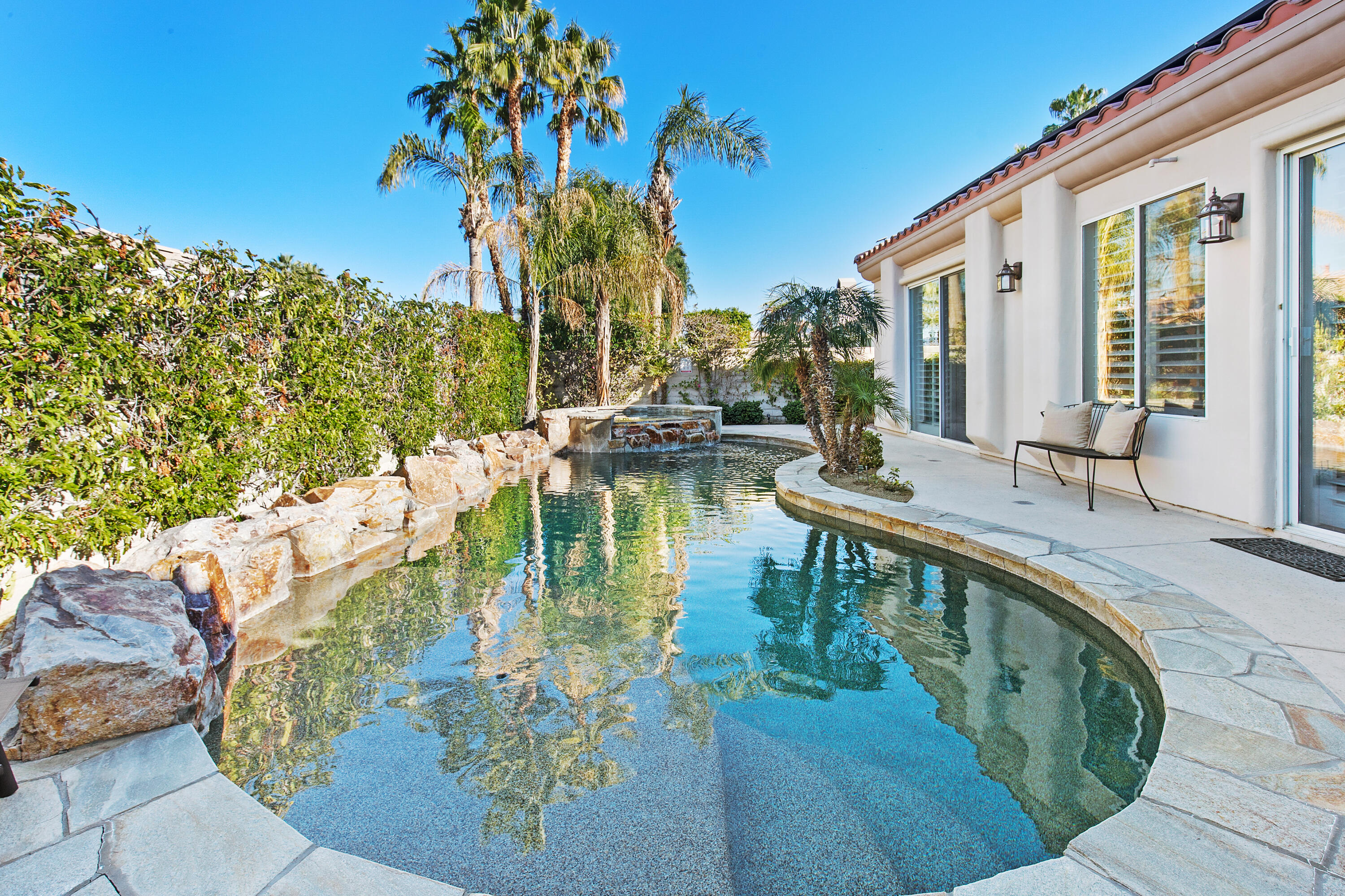 a swimming pool with outdoor seating and yard