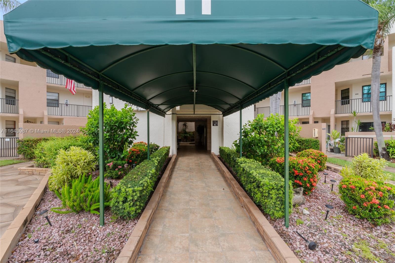 a view of a patio with table and chairs under an umbrella