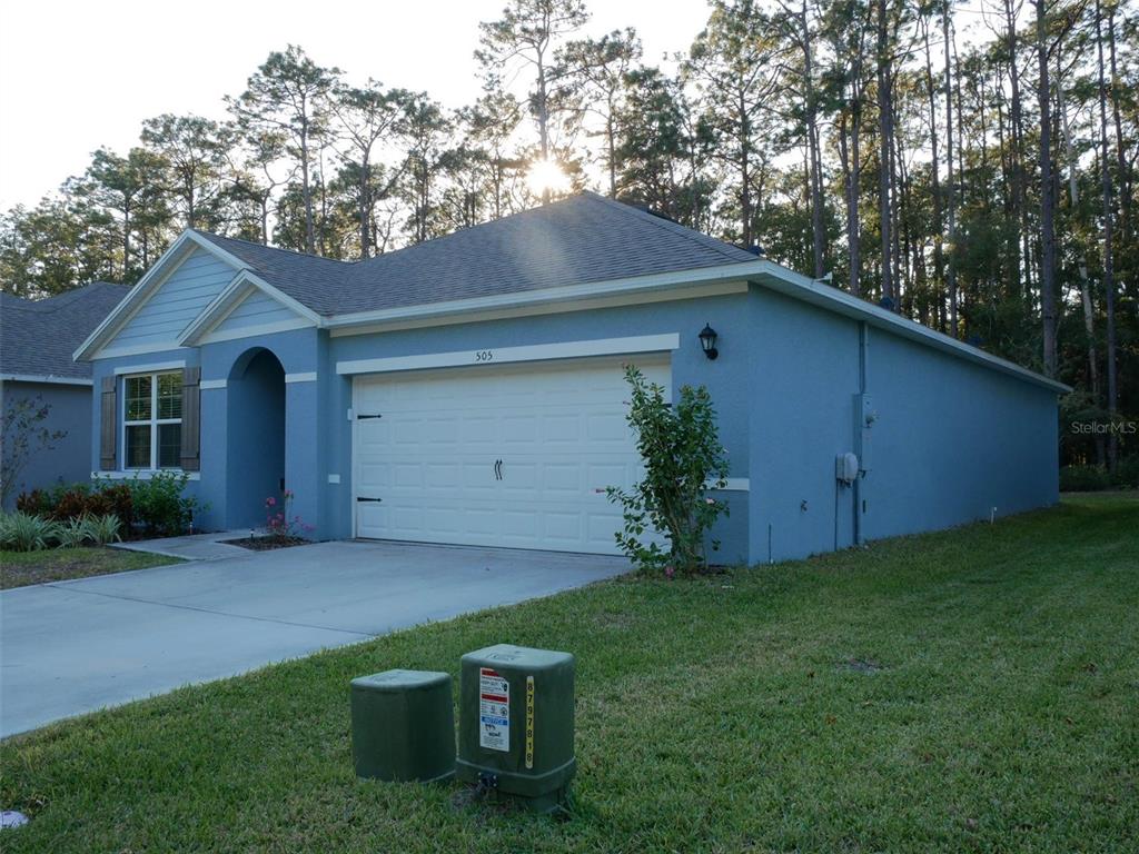 a front view of a house with garden