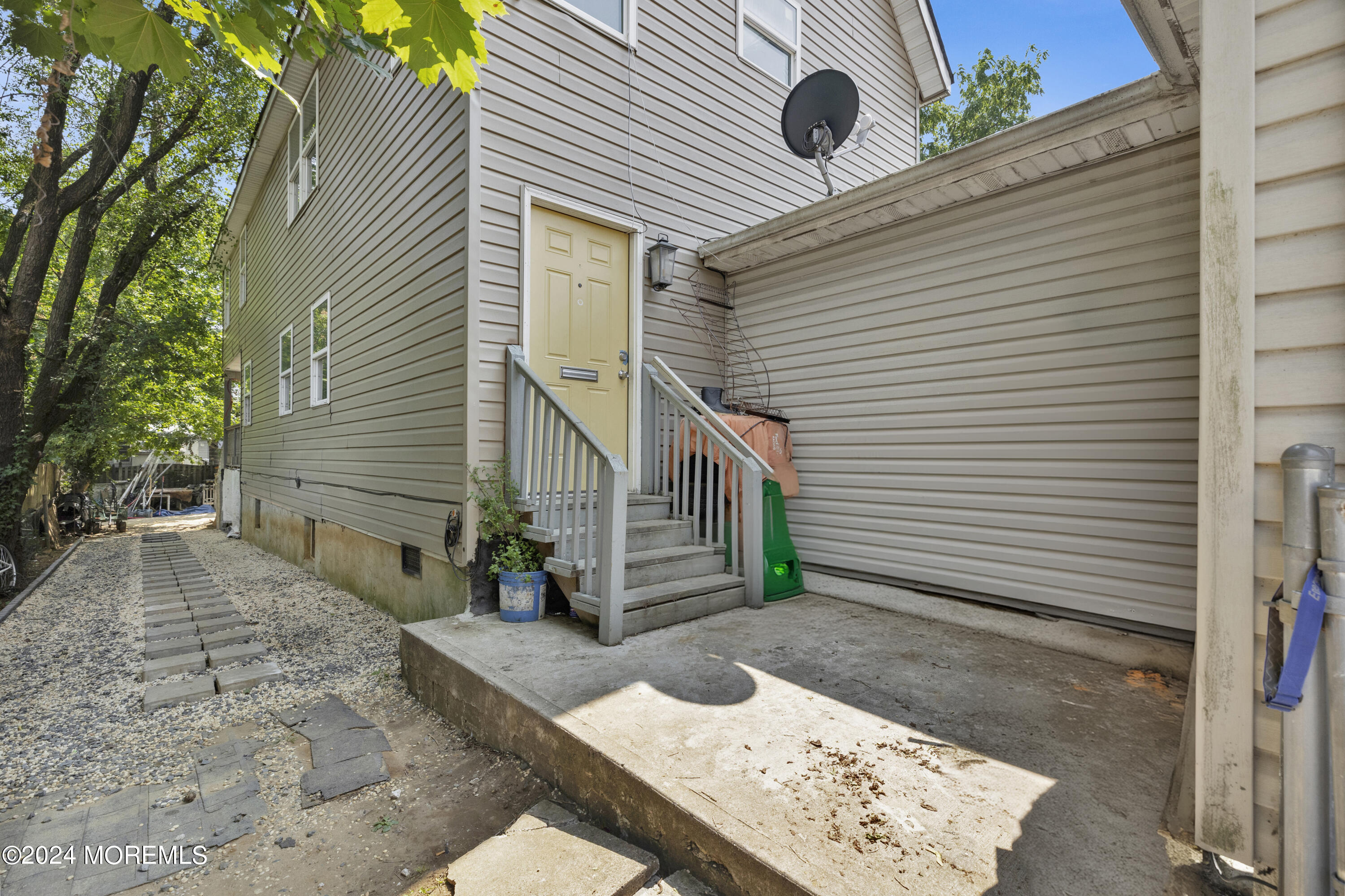 a view of a house with a yard and a tree