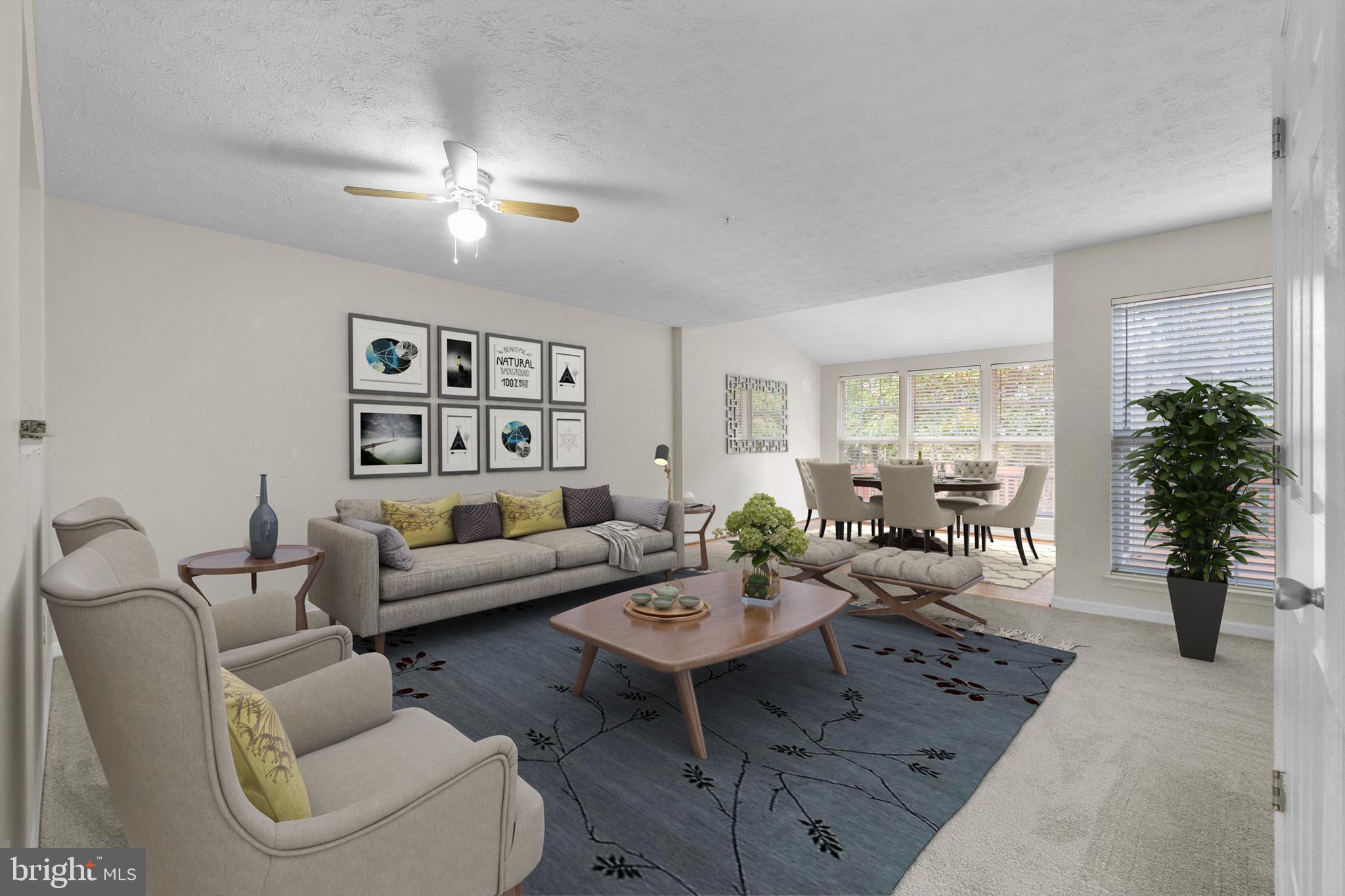 a living room with furniture and view of kitchen