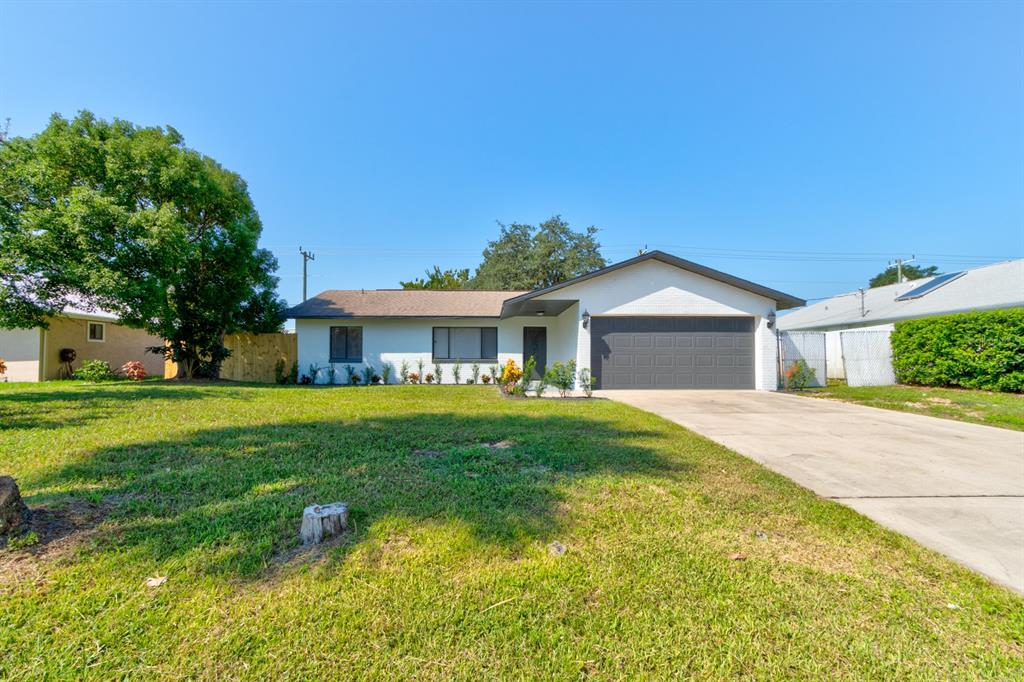 a front view of a house with yard and green space