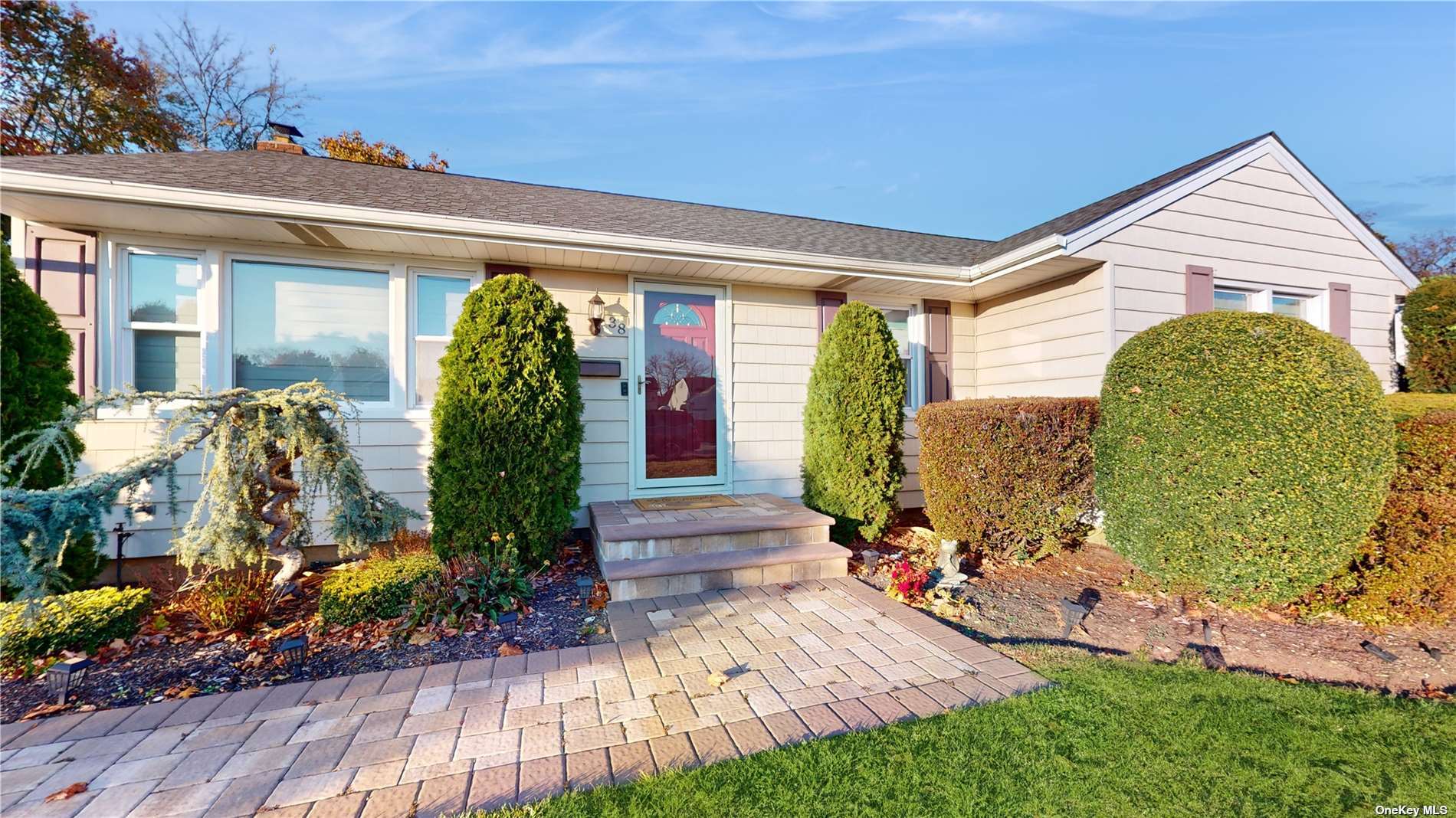 a front view of a house with garden