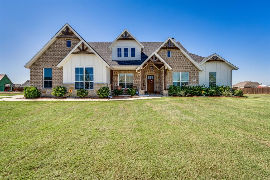 a front view of house with yard and green space