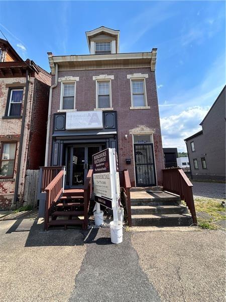 a front view of a house with stairs