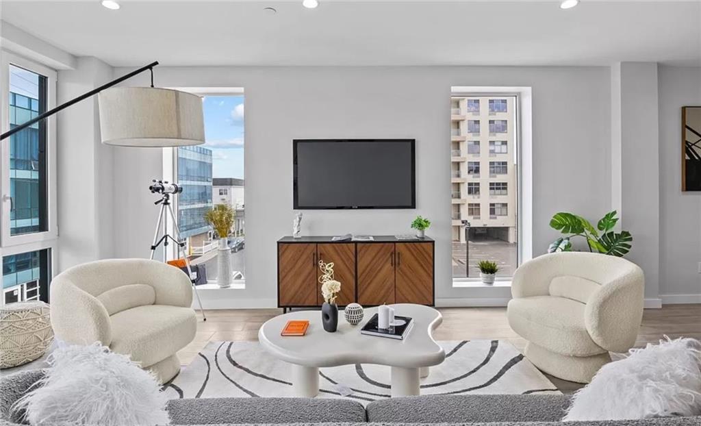 a living room with furniture a fireplace and a flat screen tv