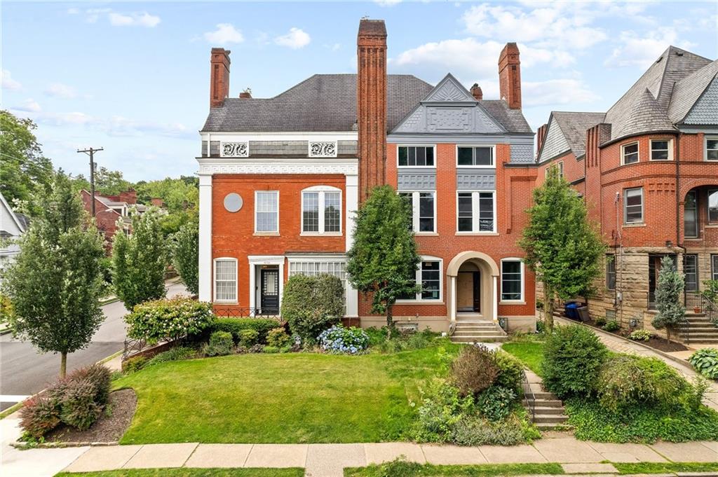 a front view of a house with a garden