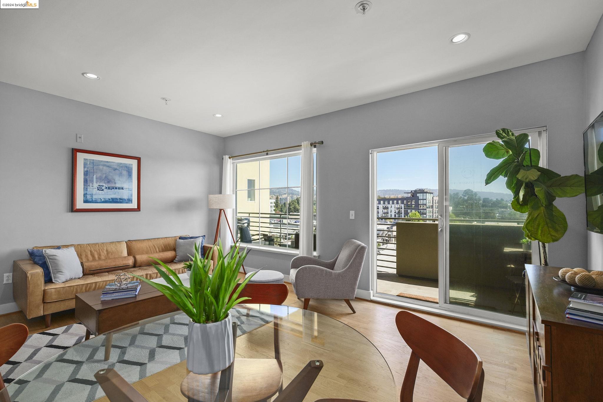 a living room with furniture potted plant and a table