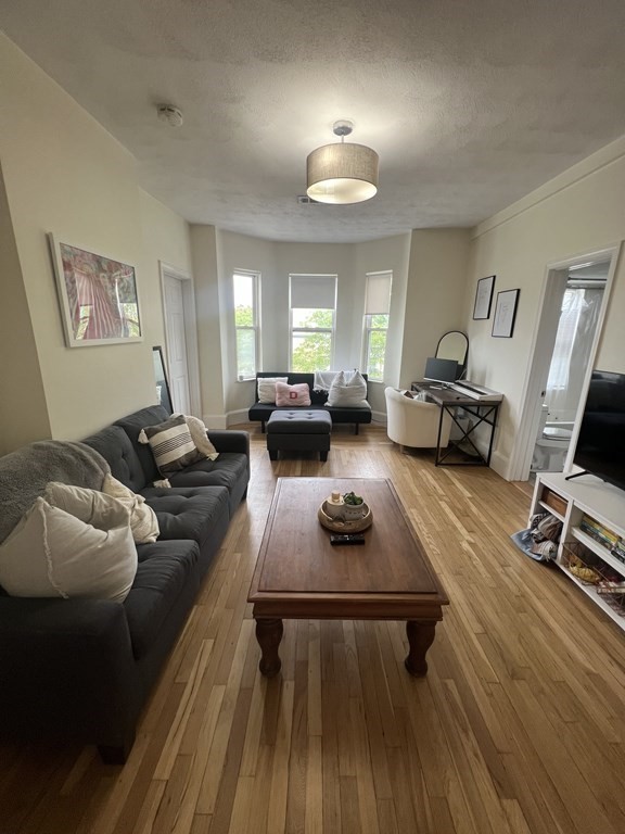 a living room with furniture rug and window