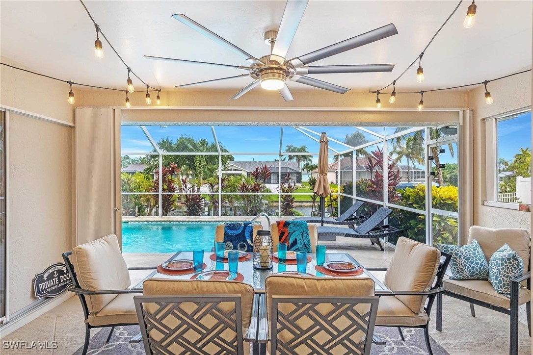 a dining room with furniture and chandelier