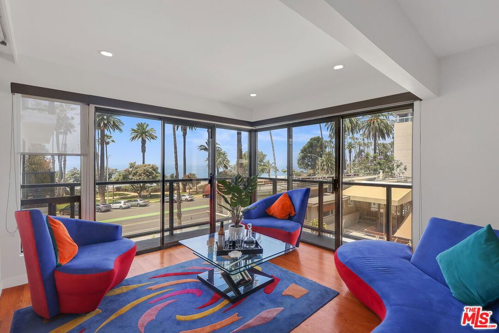 a living room with furniture and a floor to ceiling window