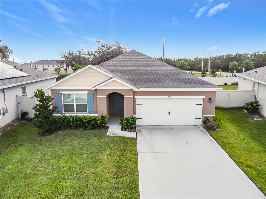 a aerial view of a house with a yard and garage