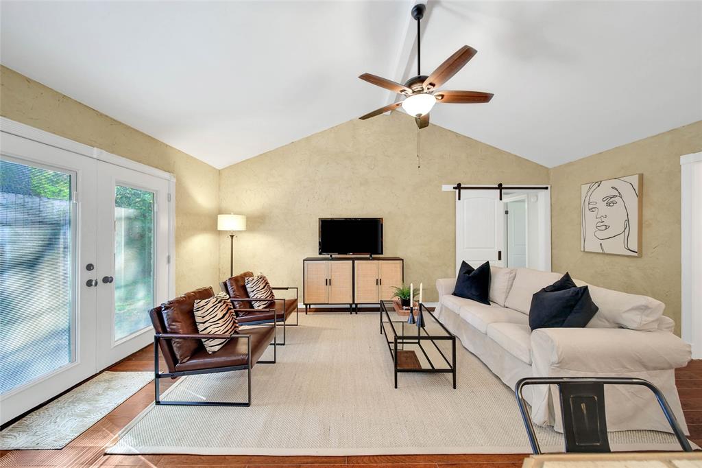 Gather and entertain in the living room with its stunning vaulted ceiling and hardwood floors.