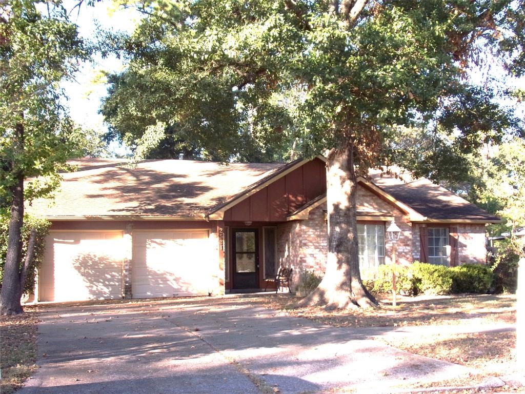 a view of a house with a tree in front