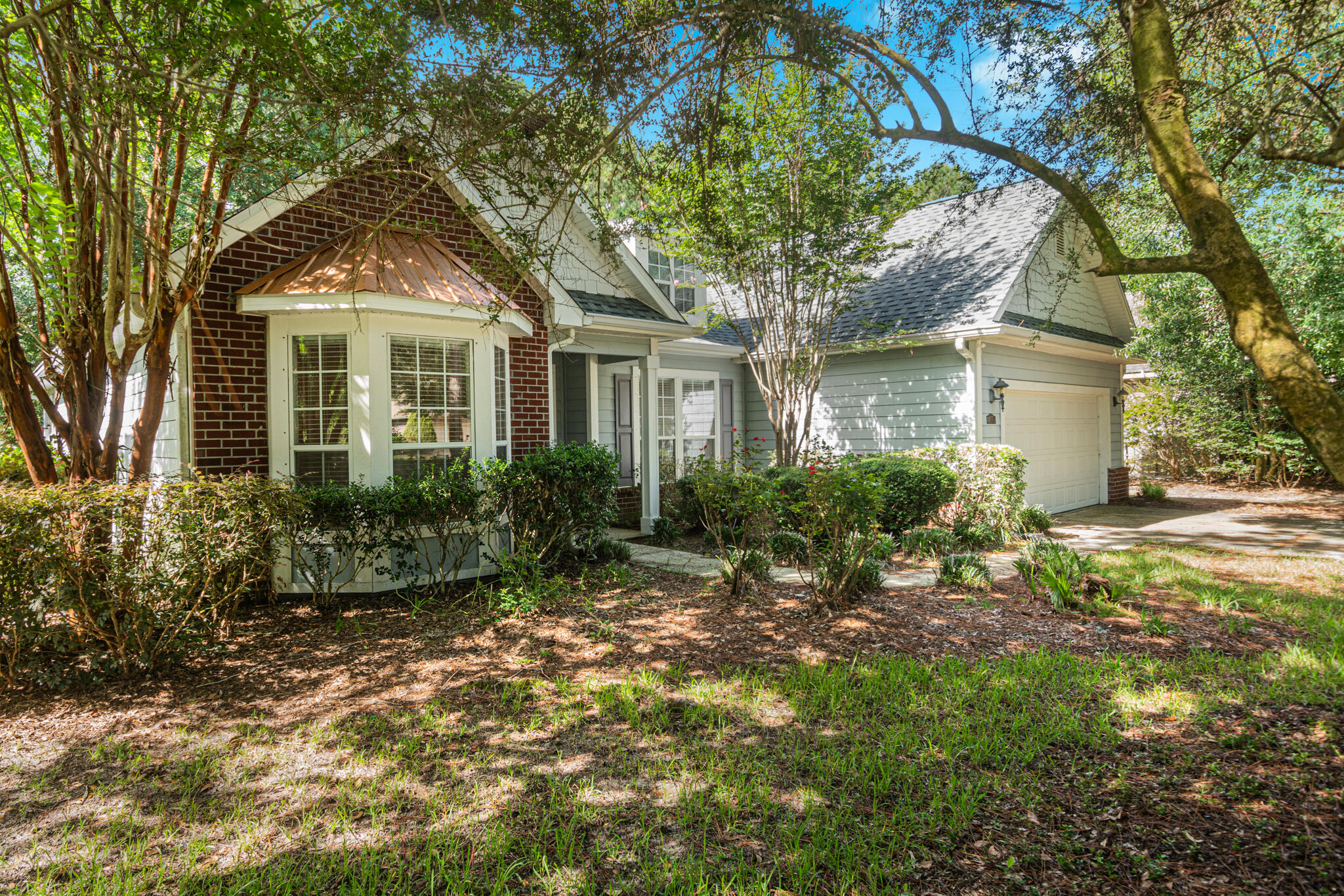 a front view of a house with a garden