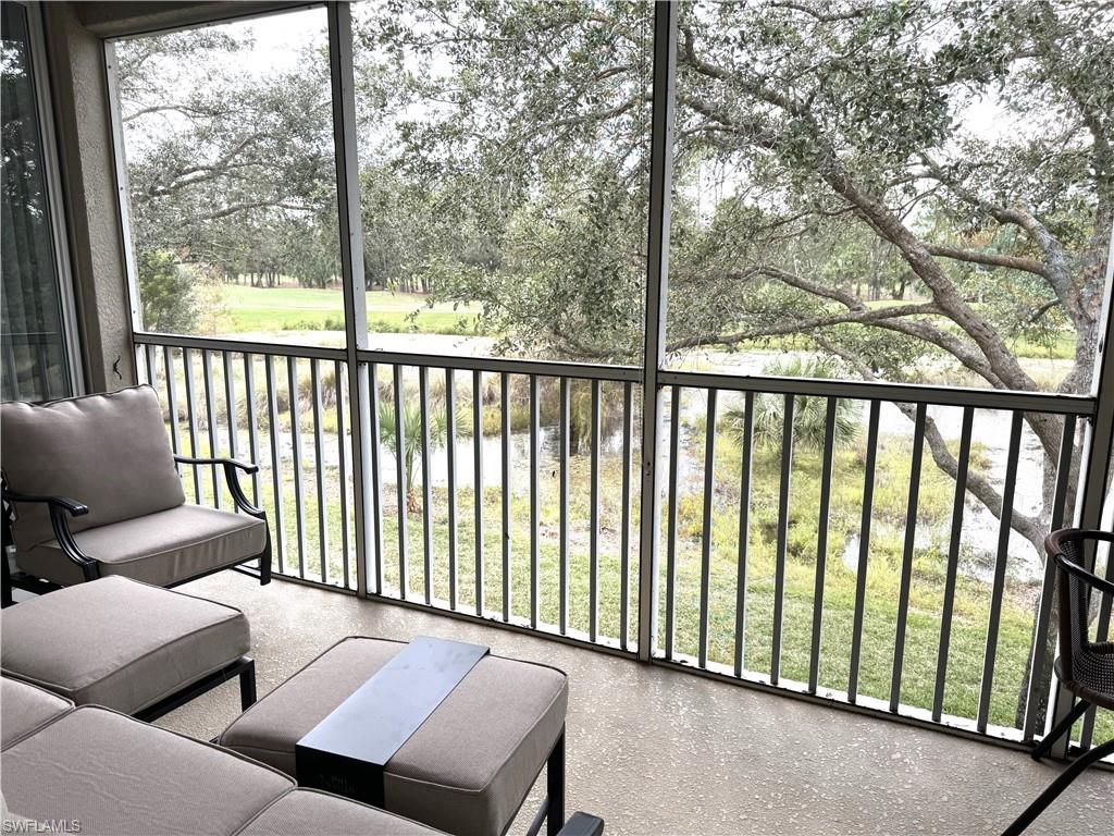 a balcony with couple of chairs and a couch