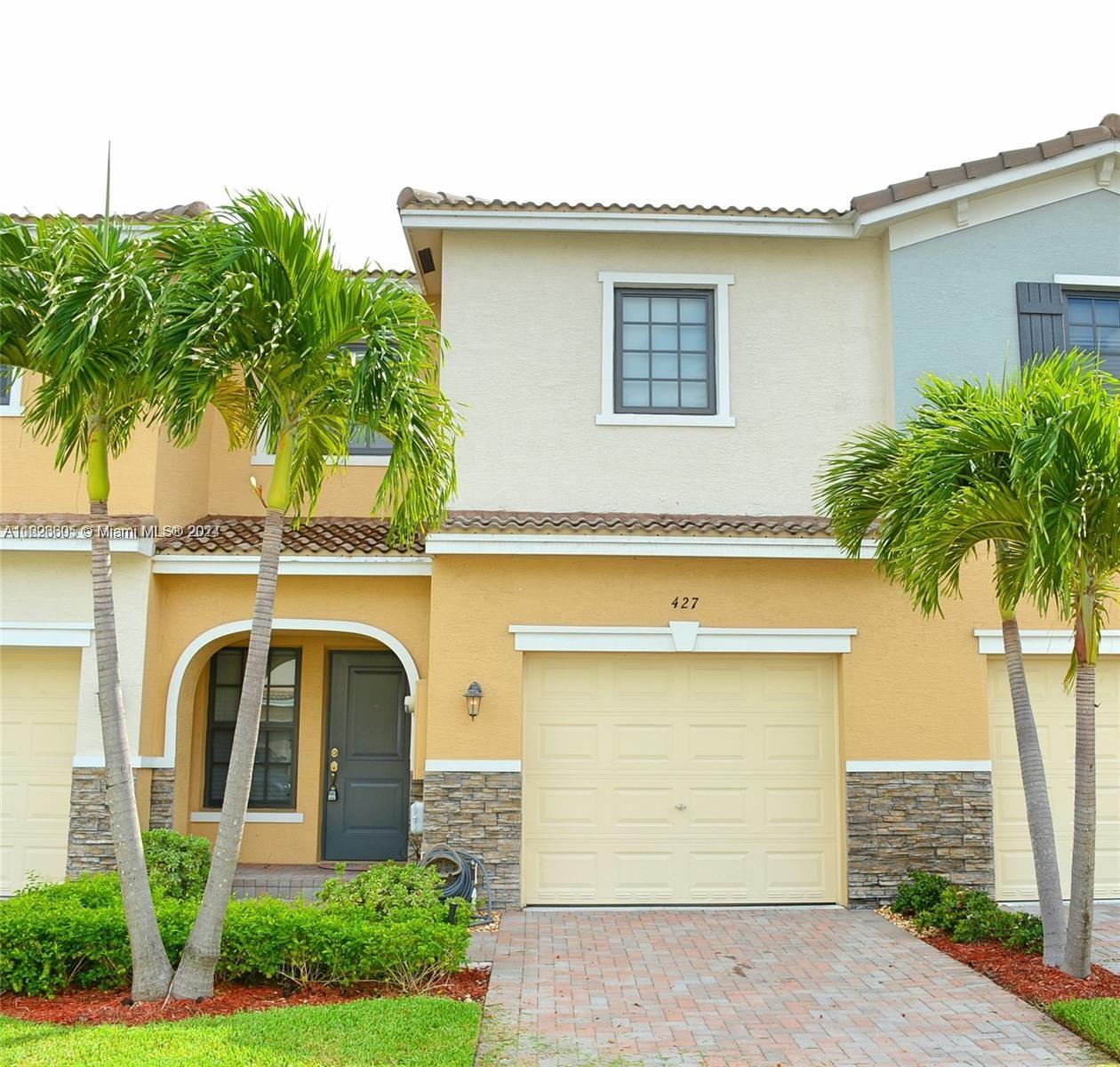 a front view of a house with a garage